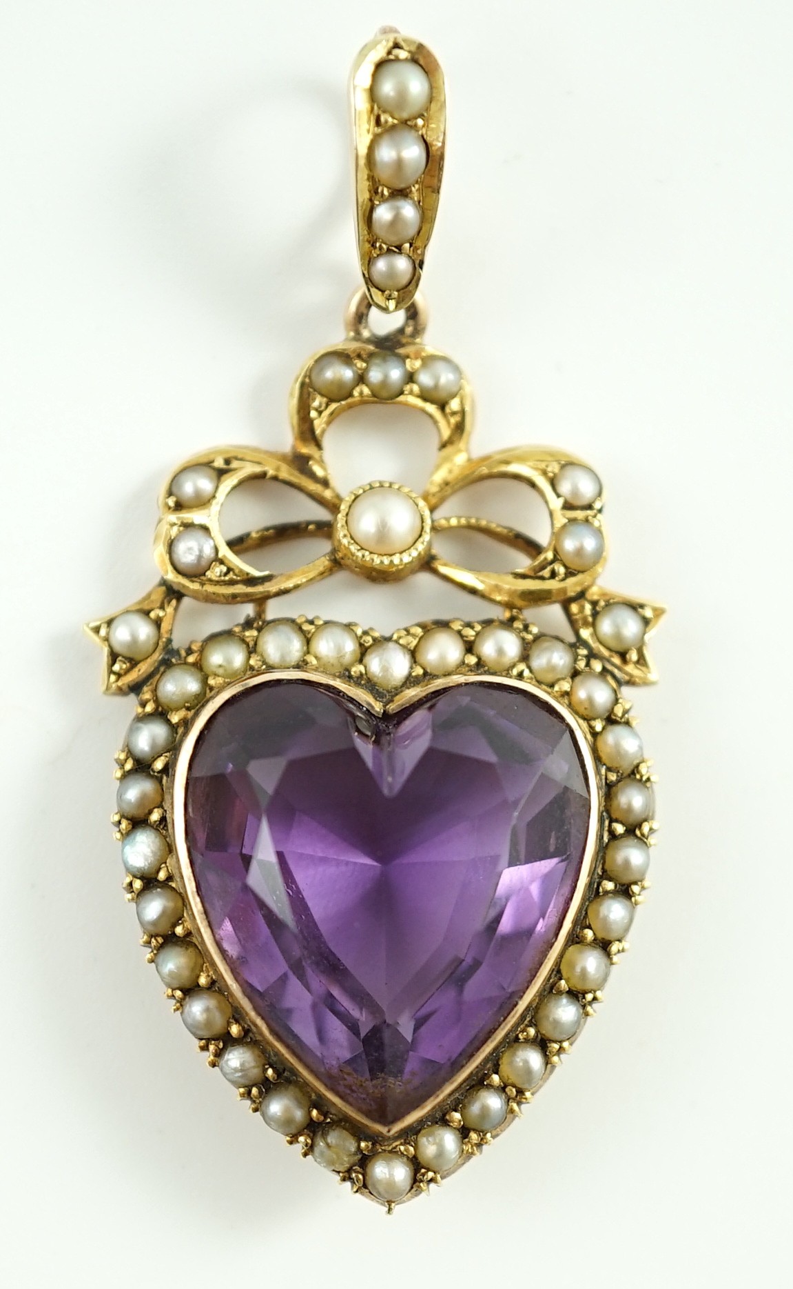 A late Victorian gold, heart shaped amethyst and seed pearl set drop pendant